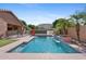 Sparkling blue pool with water feature and safety fence in a private backyard oasis at 1506 E Branham Ln, Phoenix, AZ 85042