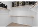 Spacious walk-in closet featuring ample shelving and storage space, providing organization and convenience at 1506 E Branham Ln, Phoenix, AZ 85042
