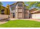 Backyard featuring green lawn, brick patio, and privacy fence, perfect for outdoor entertaining and relaxation at 1515 E South Fork Dr, Phoenix, AZ 85048