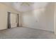 Spacious bedroom with neutral walls, plush carpet, and a window providing natural light at 1515 E South Fork Dr, Phoenix, AZ 85048