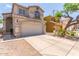 The two-story home features a neutral exterior, a well-manicured yard, and a two-car garage at 1515 E South Fork Dr, Phoenix, AZ 85048
