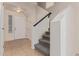 A welcoming foyer featuring tiled floors, a staircase leading to the upper level, and a front door with secure lock at 1515 E South Fork Dr, Phoenix, AZ 85048
