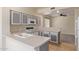 Cozy kitchen features white appliances, gray cabinets, ample counter space, and an open view to the living area at 1515 E South Fork Dr, Phoenix, AZ 85048