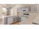 Well-lit kitchen featuring white appliances, gray cabinetry, plenty of counter space and direct access to the outdoors at 1515 E South Fork Dr, Phoenix, AZ 85048