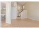 An open living area featuring neutral tiling and a staircase leading upstairs, creating an inviting, spacious entryway at 1515 E South Fork Dr, Phoenix, AZ 85048