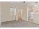 Bright living room with neutral walls and plush carpeting, leading to the kitchen and stairs at 1515 E South Fork Dr, Phoenix, AZ 85048