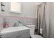 Simple bathroom with a sink, toilet, and tiled walls at 1527 W Roma Ave, Phoenix, AZ 85015