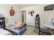 Bedroom featuring a single bed, cartoon poster, and a window for light at 1527 W Roma Ave, Phoenix, AZ 85015