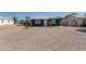 A single story home with gravel landscaping and a freshly painted dark gray exterior at 1527 W Roma Ave, Phoenix, AZ 85015