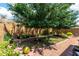 Spacious backyard with mature shade trees, a swing set, and low-maintenance landscaping at 16833 N 113Th Ave, Surprise, AZ 85378