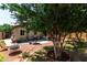 Private backyard featuring shade trees, patio furniture, and a BBQ grill for outdoor entertainment at 16833 N 113Th Ave, Surprise, AZ 85378