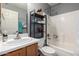 Clean bathroom features a shower and tub combination, storage shelf, and a functional single sink at 16833 N 113Th Ave, Surprise, AZ 85378