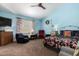 Cozy bedroom featuring a large window, ceiling fan, and comfortable furnishings at 16833 N 113Th Ave, Surprise, AZ 85378