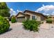 Charming home showcasing a two-car garage, manicured shrubs, and a well-maintained driveway at 16833 N 113Th Ave, Surprise, AZ 85378