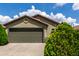 Charming home showcasing a two-car garage, manicured shrubs, and a well-maintained driveway at 16833 N 113Th Ave, Surprise, AZ 85378