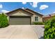 Charming single-story home featuring a well-maintained front yard with a two-car garage and neutral toned paint at 16833 N 113Th Ave, Surprise, AZ 85378