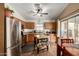 Functional kitchen featuring oak cabinets, stainless steel appliances, and adjacent dining space at 16833 N 113Th Ave, Surprise, AZ 85378