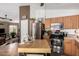 Bright kitchen features stainless steel appliances and center island for food preparation and entertaining at 16833 N 113Th Ave, Surprise, AZ 85378