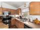 Well-lit kitchen showcases ample cabinet space, modern appliances, and a convenient double sink at 16833 N 113Th Ave, Surprise, AZ 85378