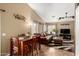 Open-concept living space showcasing a dining area, comfortable seating, and lots of natural light at 16833 N 113Th Ave, Surprise, AZ 85378