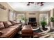 Comfortable living room featuring a leather sofa, vaulted ceiling, and a unique area rug at 16833 N 113Th Ave, Surprise, AZ 85378