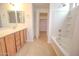 Bright bathroom featuring a double vanity, shower over tub, and walk-in closet at 1789 E Desert Breeze Pl, Casa Grande, AZ 85122