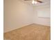 Cozy bedroom features neutral walls, plush carpet, and a ceiling fan for added comfort at 1789 E Desert Breeze Pl, Casa Grande, AZ 85122