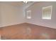 Spacious bedroom featuring wood floors, two windows, and ceiling fan at 1789 E Desert Breeze Pl, Casa Grande, AZ 85122