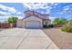 Inviting two-story home featuring a three-car garage and a well-maintained, low-maintenance desert landscape at 1789 E Desert Breeze Pl, Casa Grande, AZ 85122