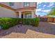 Landscaped front yard featuring a trimmed hedge, decorative rock, and a covered entry porch at 1789 E Desert Breeze Pl, Casa Grande, AZ 85122