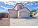 Home featuring a three-car garage, a concrete driveway, and low-maintenance desert landscape at 1789 E Desert Breeze Pl, Casa Grande, AZ 85122