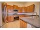 Well-equipped kitchen with modern stainless steel appliances, granite countertops, and wood cabinetry at 1789 E Desert Breeze Pl, Casa Grande, AZ 85122