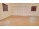 Open-concept living area featuring tile floors, built-in shelves, and window shutters at 1789 E Desert Breeze Pl, Casa Grande, AZ 85122
