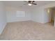 Large, carpeted living room with ceiling fan at 1789 E Desert Breeze Pl, Casa Grande, AZ 85122