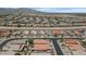Wide aerial shot of a housing development in a desert setting with tiled roofs, solar panels and mountain views at 18089 W Weatherby Dr, Surprise, AZ 85374