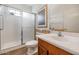 Bathroom with glass door shower and wood cabinets at 18089 W Weatherby Dr, Surprise, AZ 85374
