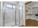 Modern shower with sliding glass doors, complemented by a walk-in closet for organized storage at 18089 W Weatherby Dr, Surprise, AZ 85374