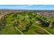 Picturesque aerial view of a lush golf course with mature trees and well-manicured fairways in a residential community at 18089 W Weatherby Dr, Surprise, AZ 85374