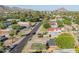 Aerial view of the residential home with palm trees and fence-enclosed front yard at 1909 E Bethany Home Rd, Phoenix, AZ 85016