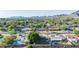 Aerial view of the residential lot with large shade tree, landscaping, and mountain views at 1909 E Bethany Home Rd, Phoenix, AZ 85016