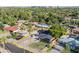 Aerial view of the residential house with a lawn, palm trees and a carport at 1909 E Bethany Home Rd, Phoenix, AZ 85016