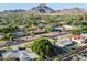 An aerial view of the residential lot with a large tree and mountain backdrop at 1909 E Bethany Home Rd, Phoenix, AZ 85016
