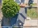 Birds-eye view of a home with a large tree, dark roof, green grass, and a basketball hoop in the driveway at 1909 E Bethany Home Rd, Phoenix, AZ 85016
