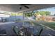 Covered patio with brick flooring and seating provides the perfect spot to enjoy the view of the backyard and garden at 1909 E Bethany Home Rd, Phoenix, AZ 85016