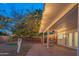 Covered patio with comfortable seating, lush greenery, and string lights creates an inviting outdoor space for relaxation and enjoyment at 1909 E Bethany Home Rd, Phoenix, AZ 85016