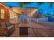 Backyard featuring a covered patio, string lights, fire pit, and lounge seating, perfect for outdoor gatherings at 1909 E Bethany Home Rd, Phoenix, AZ 85016