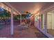 Inviting covered patio with seating, string lights, and brick flooring offers a perfect outdoor retreat for relaxation and entertaining at 1909 E Bethany Home Rd, Phoenix, AZ 85016