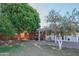 Backyard showing a brick home, patio area, mature trees, and a fruit tree, perfect for outdoor enjoyment at 1909 E Bethany Home Rd, Phoenix, AZ 85016