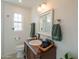 Charming bathroom featuring a vanity with wood accents, a sink, and stylish fixtures at 1909 E Bethany Home Rd, Phoenix, AZ 85016
