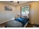 Bright bedroom featuring a single bed, stylish decor, and a view of the outdoors at 1909 E Bethany Home Rd, Phoenix, AZ 85016